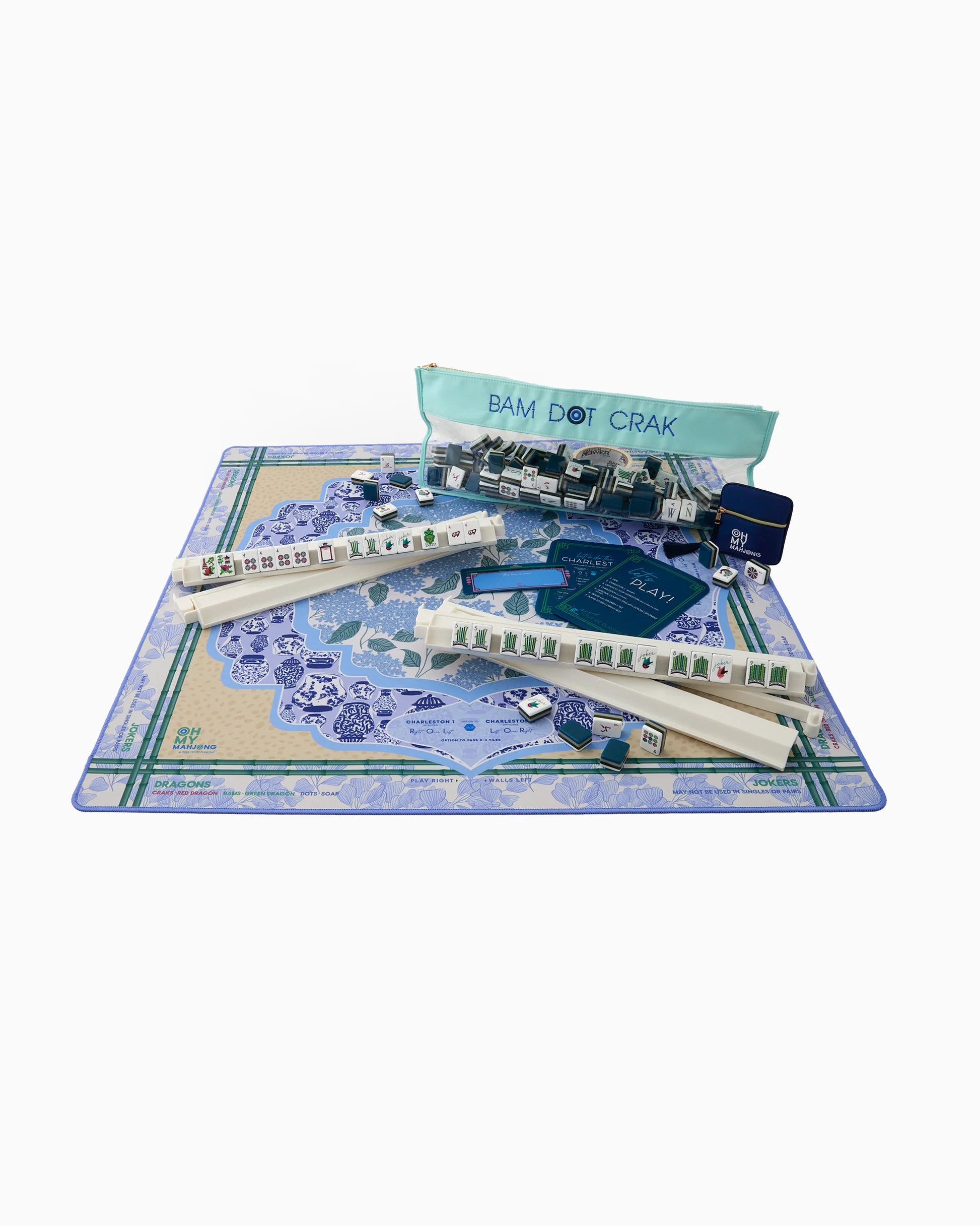 Oh My Mahjong instructional Mahjong Mat with French blue hydrangeas, chinoiserie ginger jars and ginkgo leave pattern and antelope animal patter in tan with bamboo border with white mahjong rack, navy shufflers and Gatsby tiles and mint tile storage bag and navy dice bag