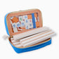 Oh My Mahjong Orange Rummi tile set with white wooden racks in storage bag with tasseled zipper